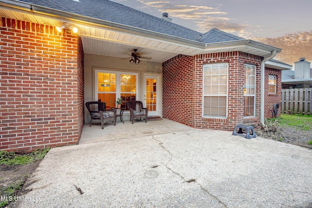 patio terrace at dusk with fence and ceiling fan