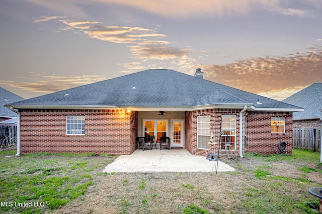 back of property featuring a patio area, fence, brick siding, and roof with shingles