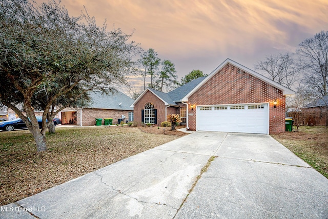 view of front of house with brick siding, concrete driveway, and a garage