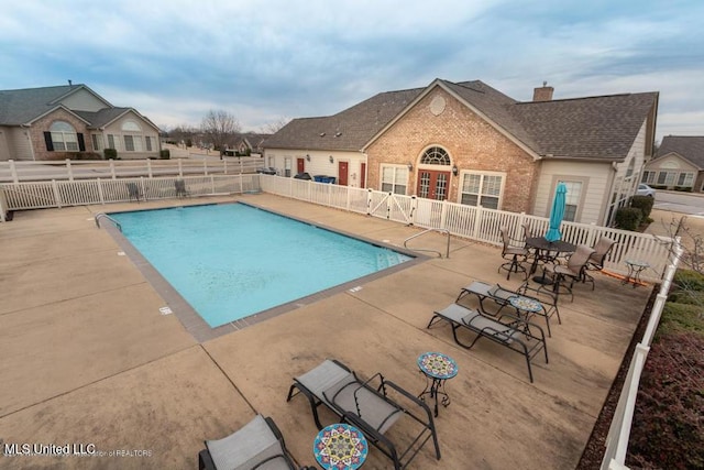 pool with fence and a patio