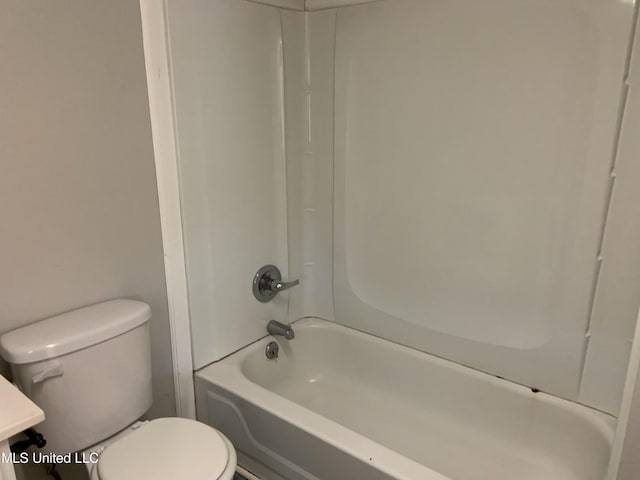 bathroom with shower / washtub combination and toilet