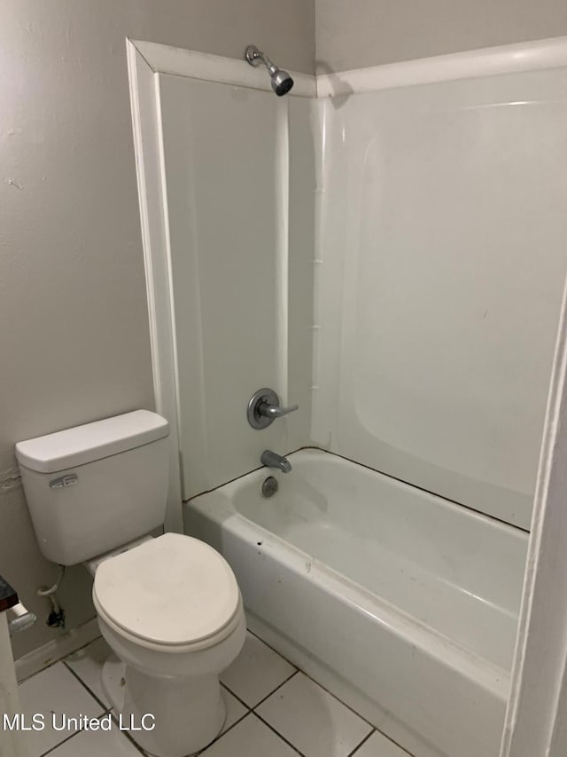 bathroom with tile patterned flooring,  shower combination, and toilet