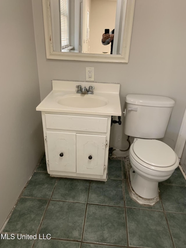 bathroom with vanity, tile patterned floors, and toilet