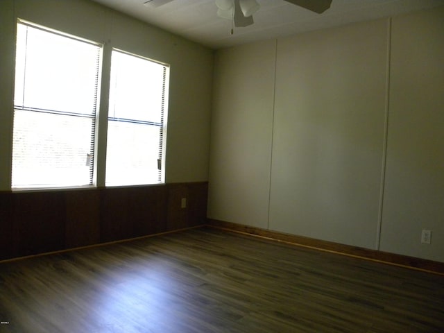 empty room with a ceiling fan and wood finished floors