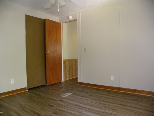 interior space with baseboards, a ceiling fan, and wood finished floors