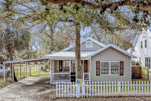 view of front of home with a carport and covered porch