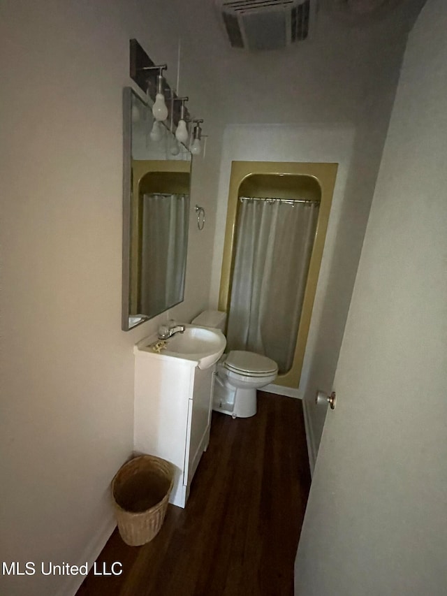 bathroom with vanity, hardwood / wood-style flooring, toilet, and a shower with curtain