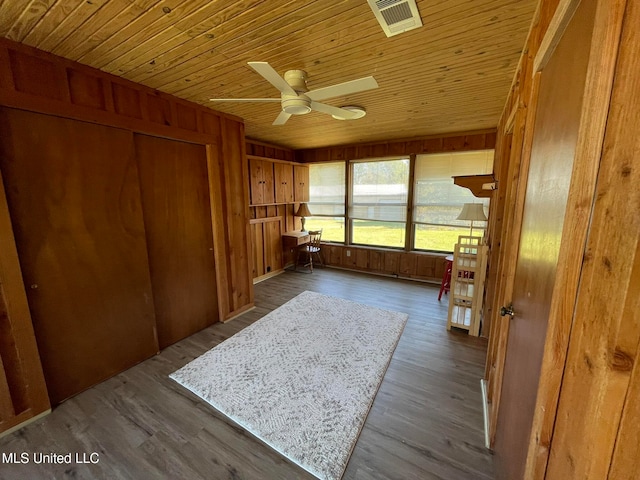 unfurnished sunroom with ceiling fan and wooden ceiling