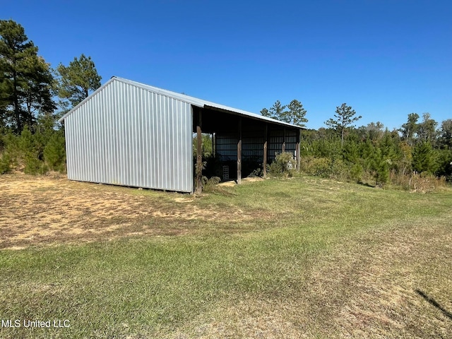 view of outbuilding featuring a lawn