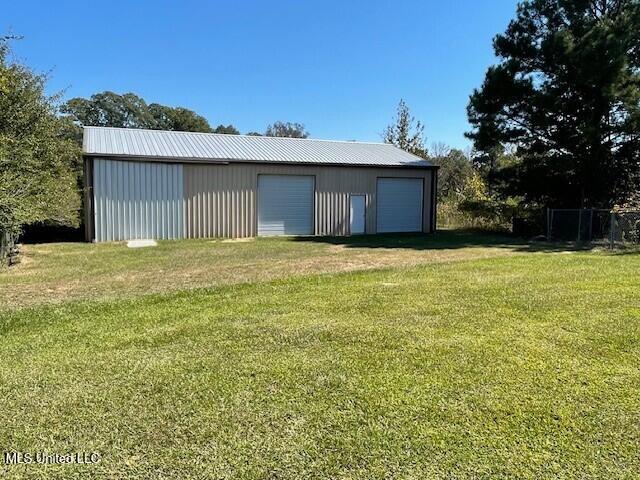 view of outbuilding featuring a yard