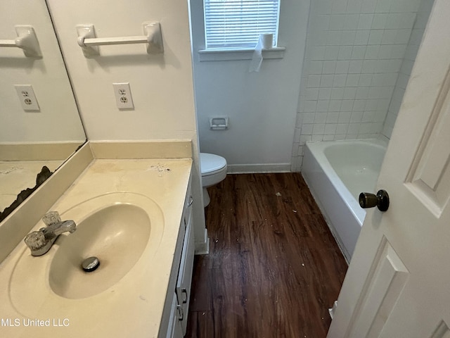 full bathroom featuring vanity, toilet, wood finished floors, and baseboards