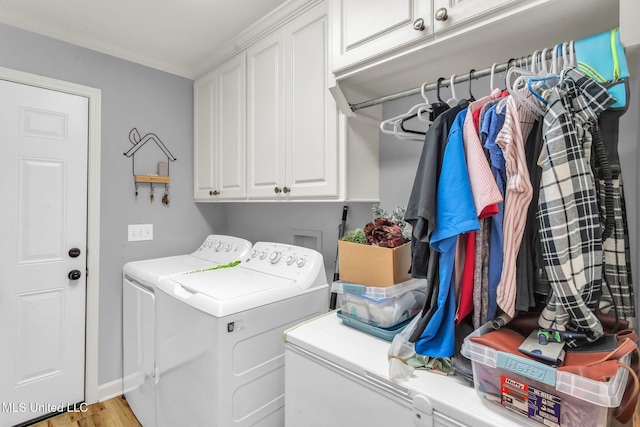 3007 Cross Point Cv, Brandon, MS 39042 - laundry room featuring washing machine and clothes dryer, cabinet space, and wood finished floors