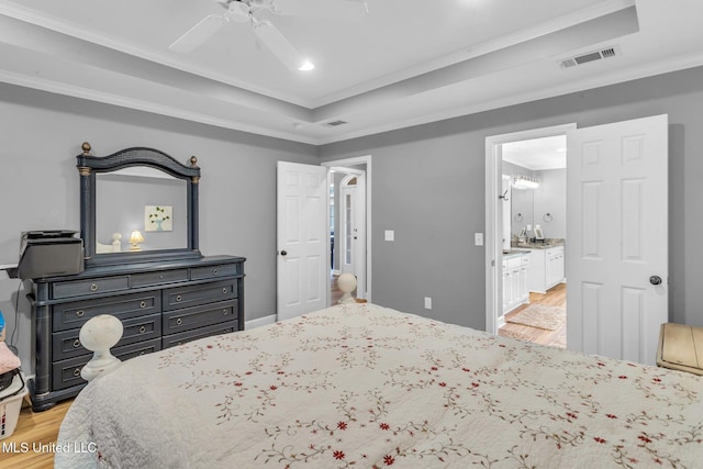 3007 Cross Point Cv, Brandon, MS 39042 - bedroom with a tray ceiling, light wood-type flooring, crown molding, connected bathroom, and recessed lighting