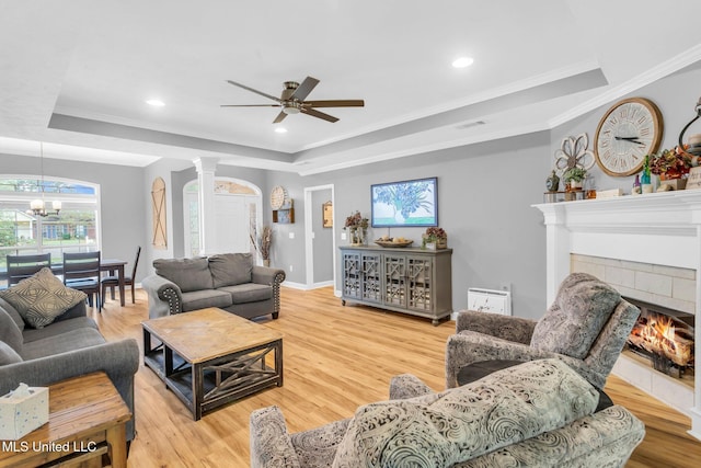 3007 Cross Point Cv, Brandon, MS 39042 - living area with a tray ceiling, plenty of natural light, crown molding, wood finished floors, and recessed lighting