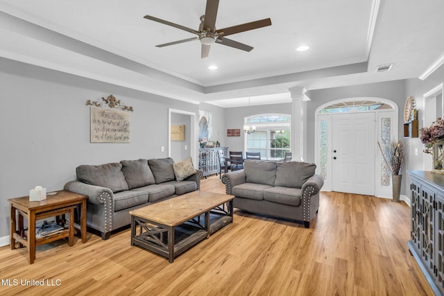 3007 Cross Point Cv, Brandon, MS 39042 - living area featuring a tray ceiling, light wood-type flooring, ornate columns, crown molding, and ceiling fan
