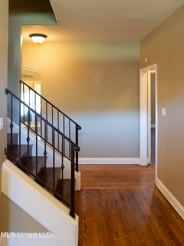 stairs featuring hardwood / wood-style floors