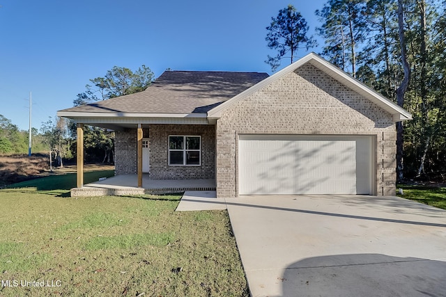 view of front of home featuring covered porch, a garage, and a front lawn