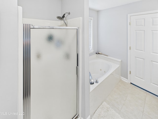 5710 Southbend Ln, Olive Branch, MS 38654 - full bath featuring a stall shower, a jetted tub, and tile patterned flooring