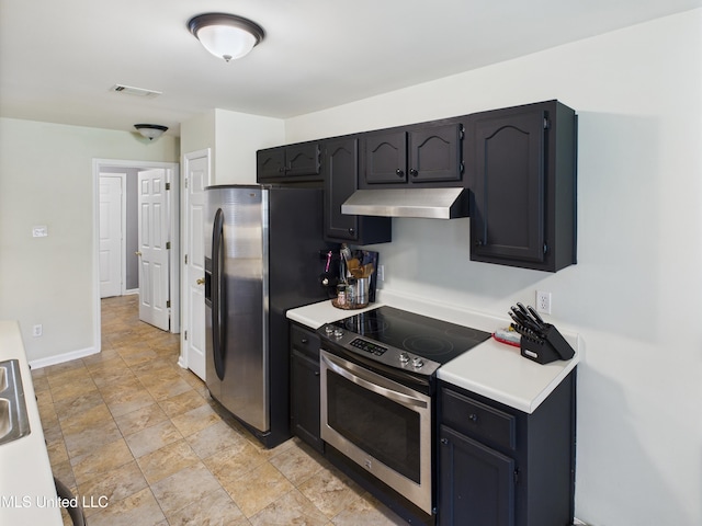 5710 Southbend Ln, Olive Branch, MS 38654 - kitchen featuring appliances with stainless steel finishes, under cabinet range hood, light countertops, and stone finish floors