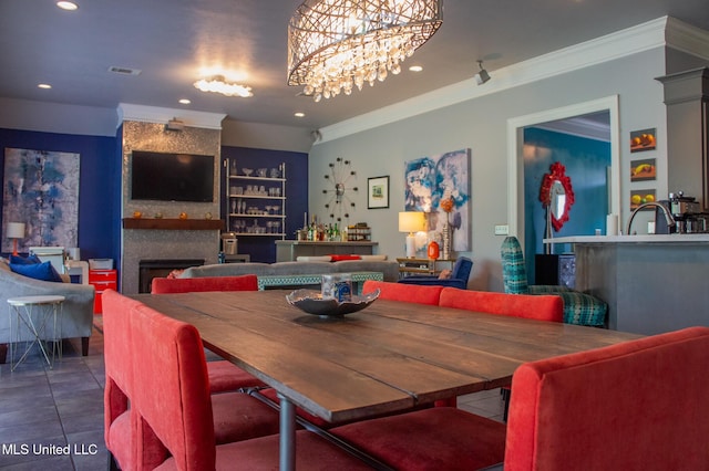 414 Spike Rdg, Canton, MS 39046 - tiled dining area featuring a large fireplace, crown molding, recessed lighting, built in shelves, and a chandelier