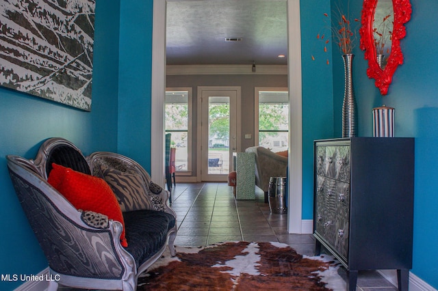 414 Spike Rdg, Canton, MS 39046 - living area featuring tile patterned flooring, baseboards, and crown molding