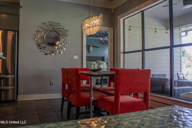 414 Spike Rdg, Canton, MS 39046 - dining area featuring ornamental molding, baseboards, dark tile patterned flooring, and a chandelier
