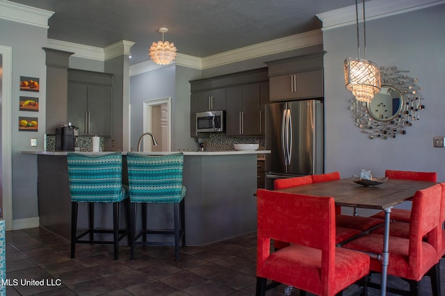 414 Spike Rdg, Canton, MS 39046 - kitchen with appliances with stainless steel finishes, decorative backsplash, crown molding, a peninsula, and light countertops