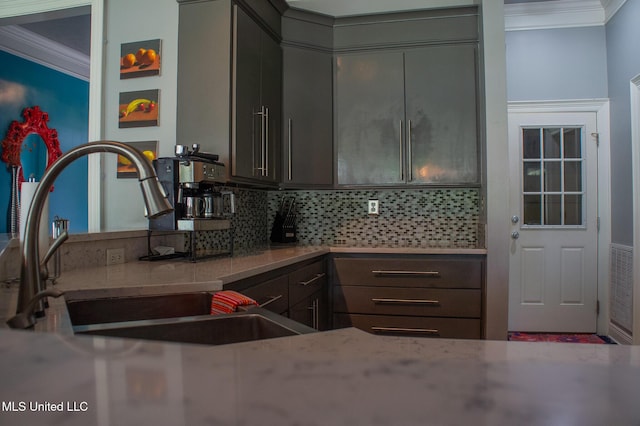 414 Spike Rdg, Canton, MS 39046 - kitchen featuring crown molding, a sink, tasteful backsplash, light stone countertops, and gray cabinetry
