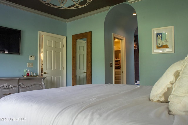 414 Spike Rdg, Canton, MS 39046 - bedroom with arched walkways, ornamental molding, and a chandelier