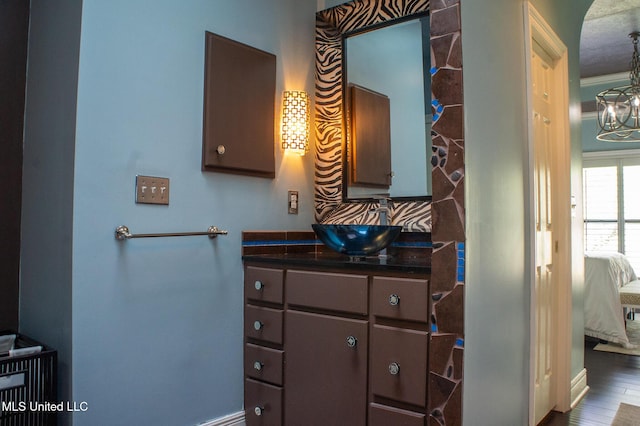 414 Spike Rdg, Canton, MS 39046 - bathroom featuring ensuite bathroom, a chandelier, vanity, baseboards, and wood finished floors