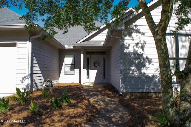 414 Spike Rdg, Canton, MS 39046 - view of exterior entry featuring a shingled roof and an attached garage