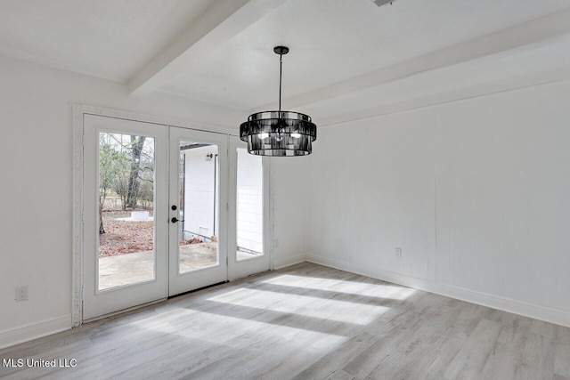 unfurnished dining area with french doors, a notable chandelier, beam ceiling, and light wood-type flooring