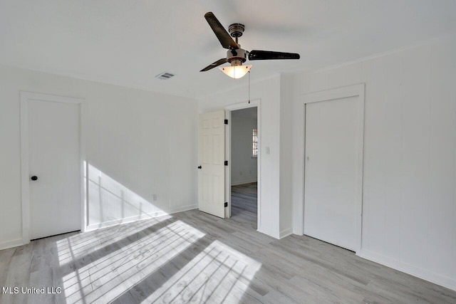 empty room with ceiling fan and light wood-type flooring