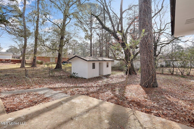 view of yard with a storage shed and a patio