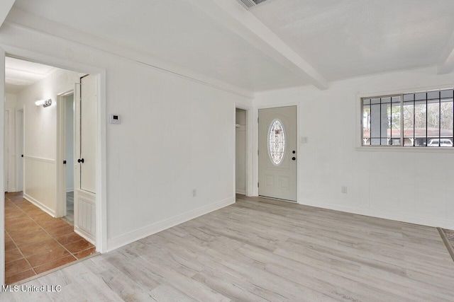 entryway with beamed ceiling and light hardwood / wood-style floors