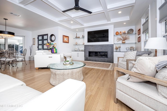 living area with light wood finished floors, visible vents, coffered ceiling, a glass covered fireplace, and recessed lighting