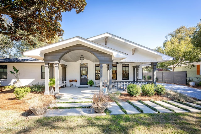 view of front facade with a porch and fence