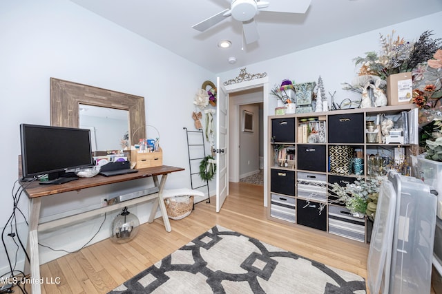 office area featuring baseboards, a ceiling fan, and wood finished floors