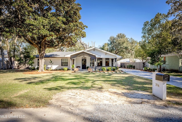 view of front of house featuring a porch, a front yard, and fence