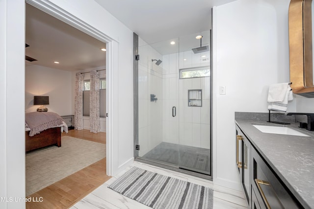 ensuite bathroom with ensuite bathroom, a stall shower, vanity, and recessed lighting