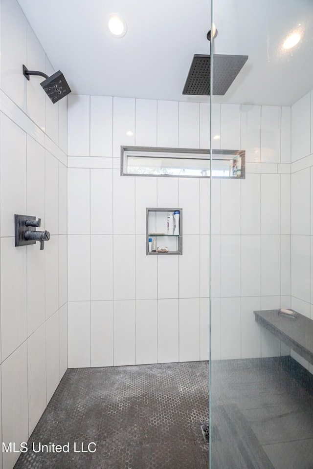 full bath with a tile shower