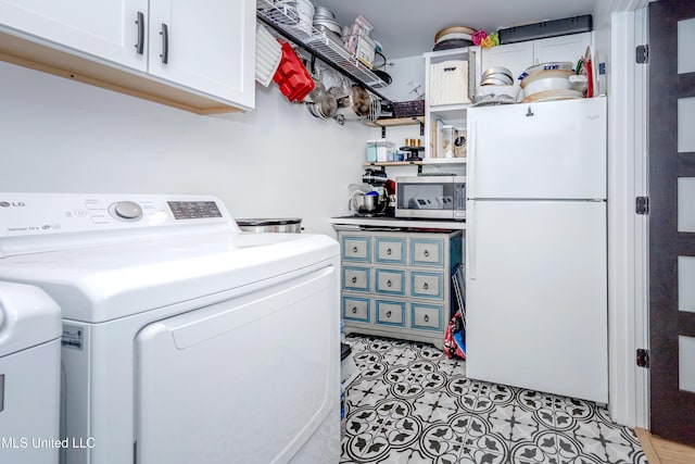 clothes washing area with cabinet space and separate washer and dryer