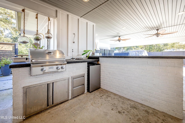 view of patio / terrace with a ceiling fan, area for grilling, and an outdoor kitchen