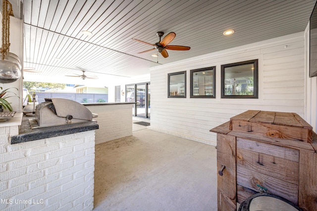 view of patio / terrace with ceiling fan, a bar, area for grilling, and fence