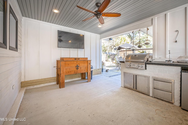 view of patio / terrace featuring a grill, an outdoor kitchen, and ceiling fan