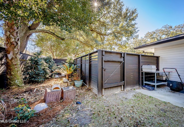 view of outbuilding featuring fence