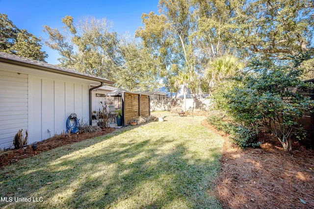 view of yard featuring fence and a pergola