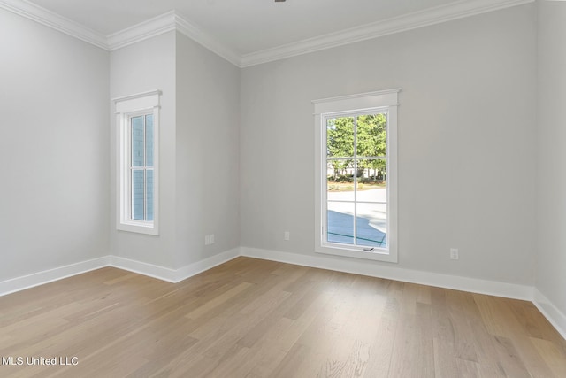 spare room featuring crown molding and light wood-type flooring