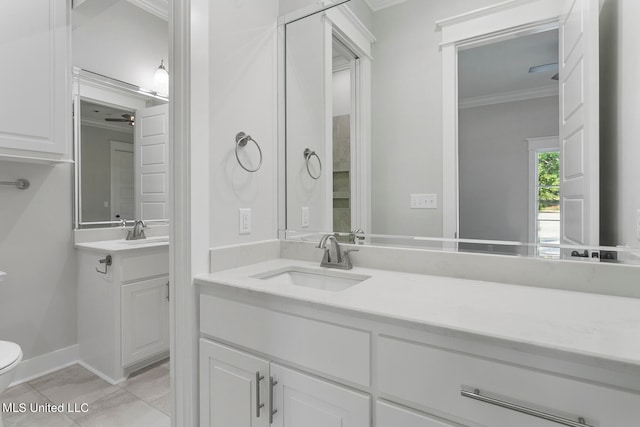 bathroom with vanity, crown molding, toilet, and tile patterned flooring