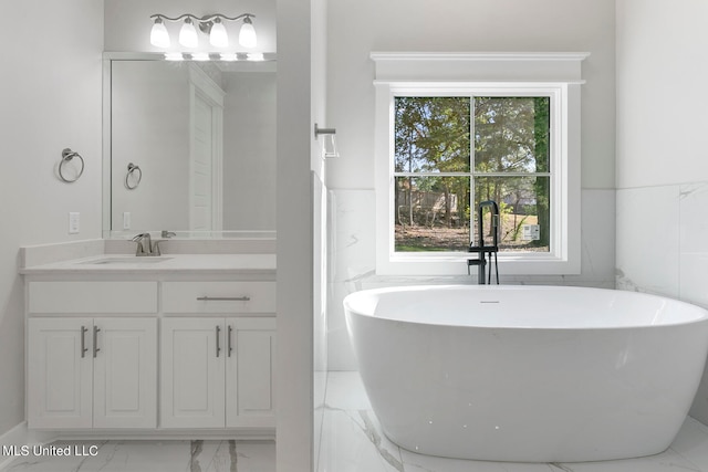 bathroom with vanity, tile walls, and a washtub